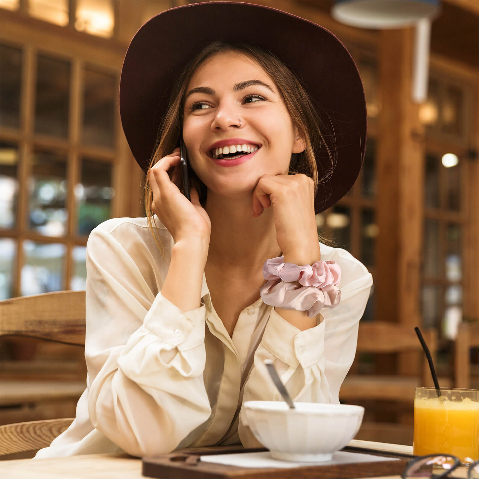 A large, champagne-colored Lolalet satin scrunchy worn on a woman's wrist as a stylish bracelet accessory.