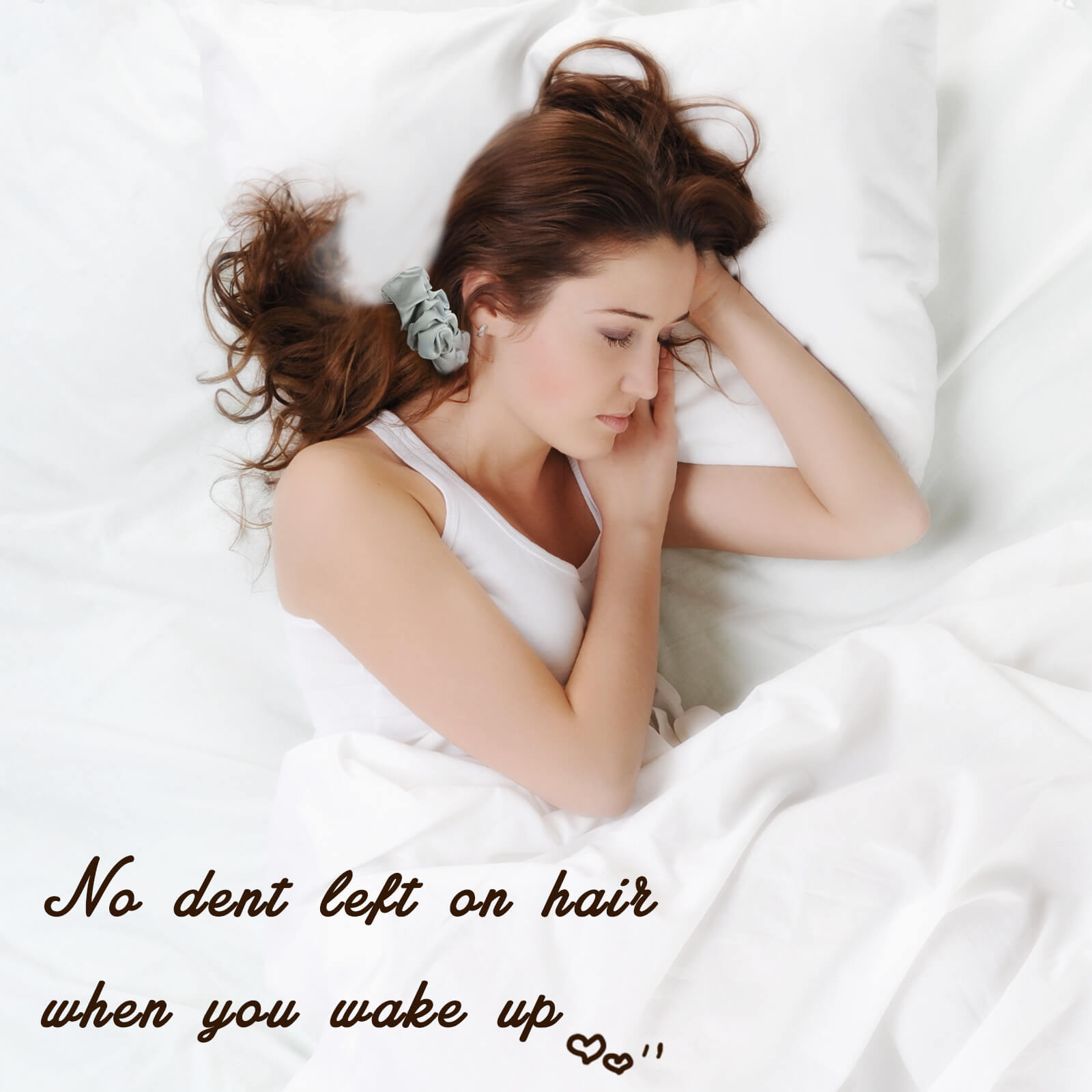 A woman with thick, long hair wearing a large pink Lolalet satin scrunchy to secure a high, voluminous ponytail.