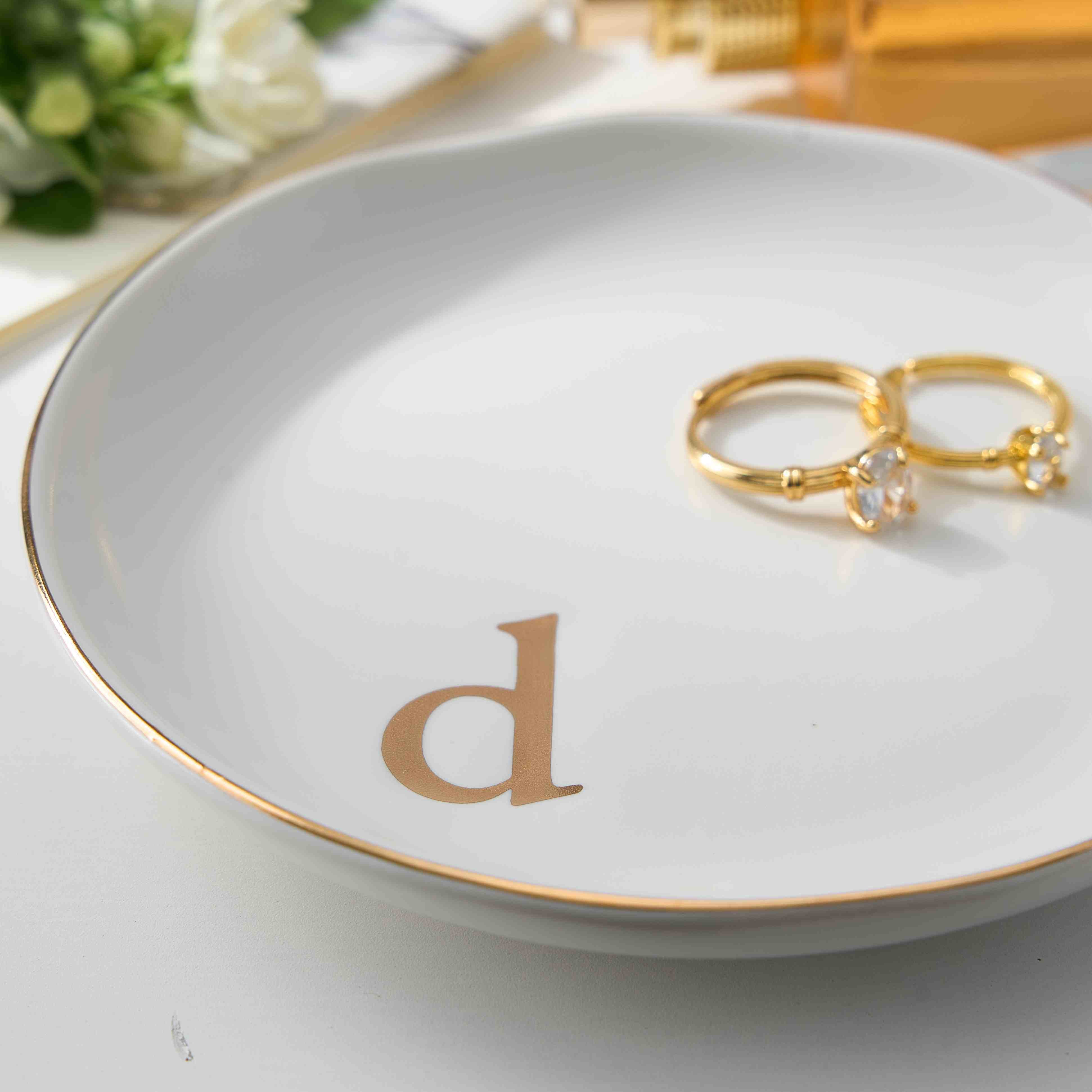 An image displaying all 26 available monogram initials (A-Z) in a gold font for the Lolalet personalized ceramic jewelry dish.