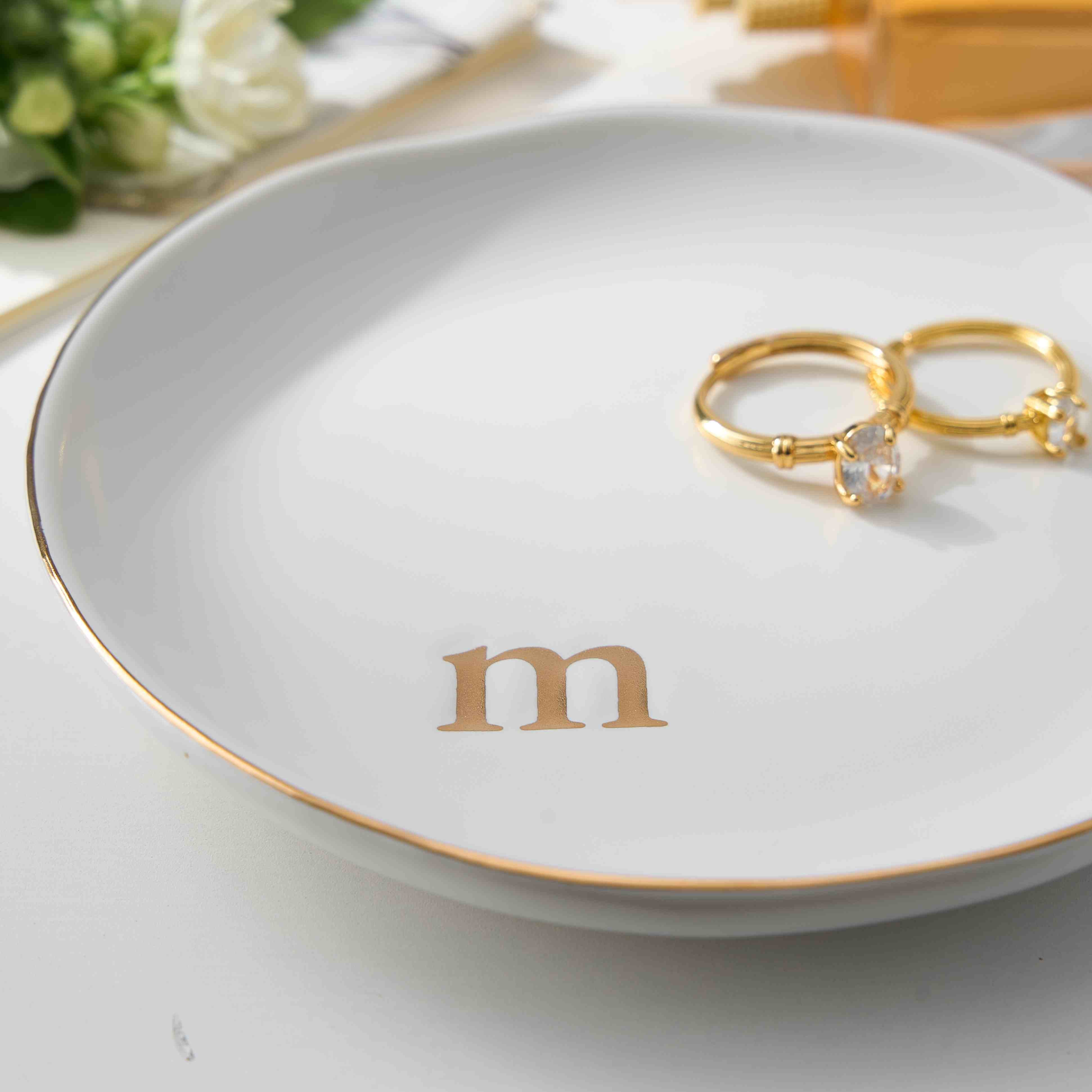 An image displaying all 26 available monogram initials (A-Z) in a gold font for the Lolalet personalized ceramic jewelry dish.