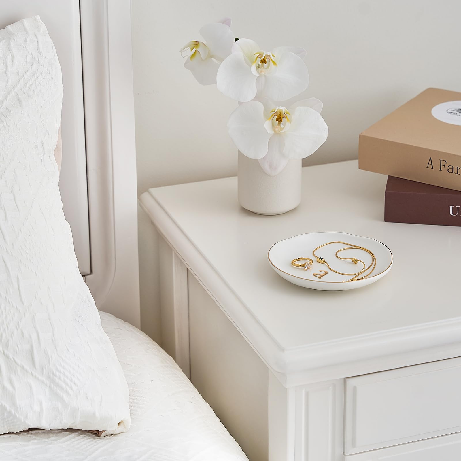 A Lolalet white ceramic jewelry dish featuring a gold "n" initial, elegantly holding an engagement ring, serving as a monogrammed ring holder.