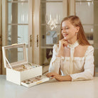The stylish Lolalet bracelet display holder sitting on a modern vanity, keeping a woman's favorite watches and jewelry organized and accessible.