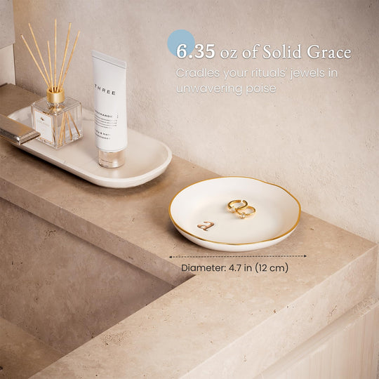 A Lolalet white ceramic jewelry dish featuring a gold 