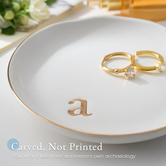 A Lolalet white ceramic jewelry dish featuring a gold 