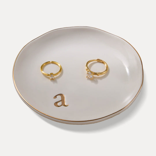 A Lolalet white ceramic jewelry dish featuring a gold 