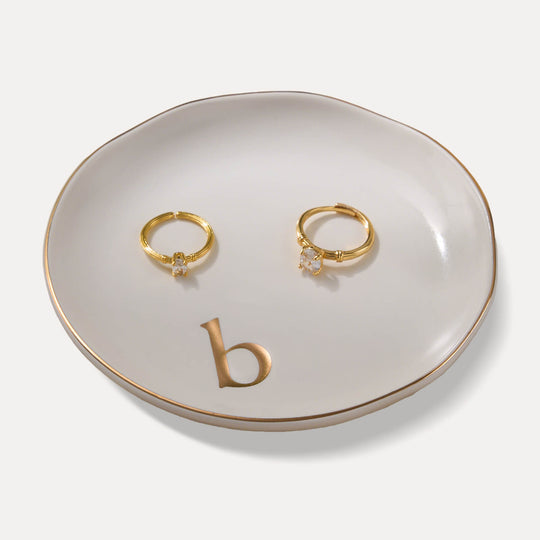 A Lolalet white ceramic jewelry dish featuring a gold 