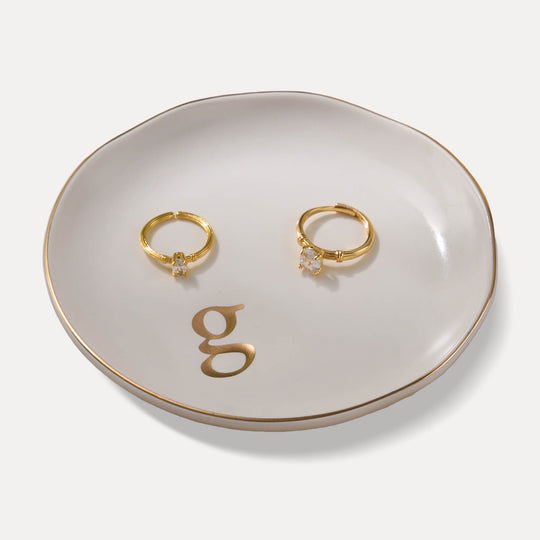 A Lolalet white ceramic jewelry dish featuring a gold 