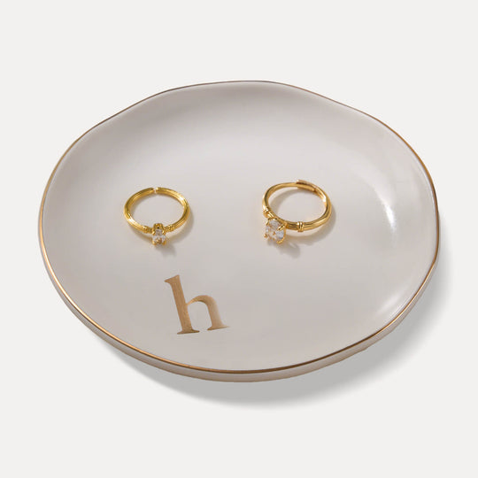 A Lolalet white ceramic jewelry dish featuring a gold 