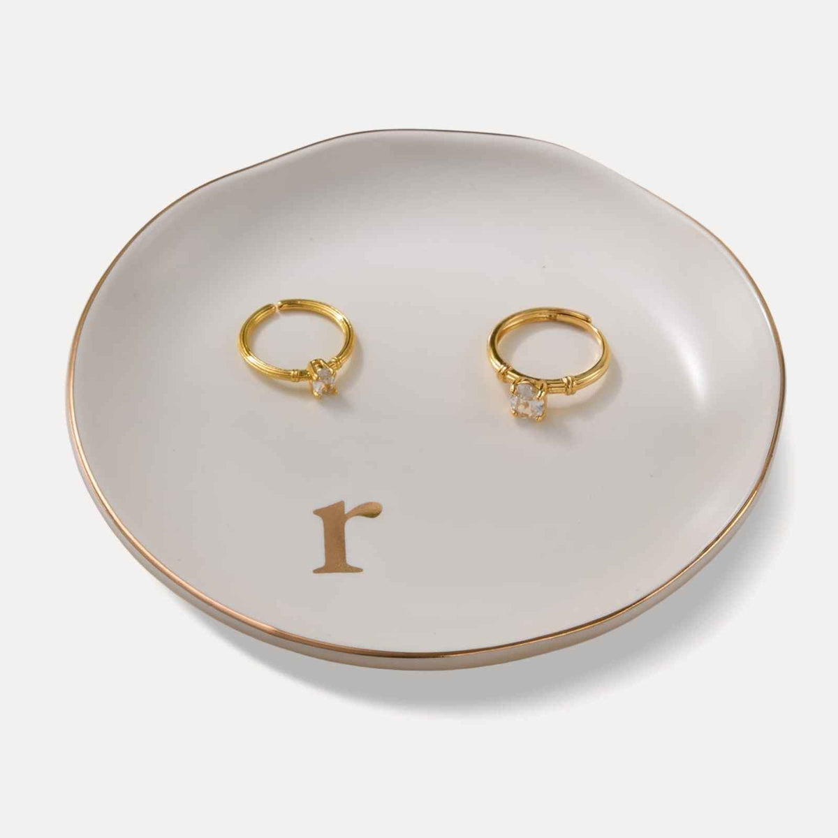 A Lolalet white ceramic jewelry dish featuring a gold 