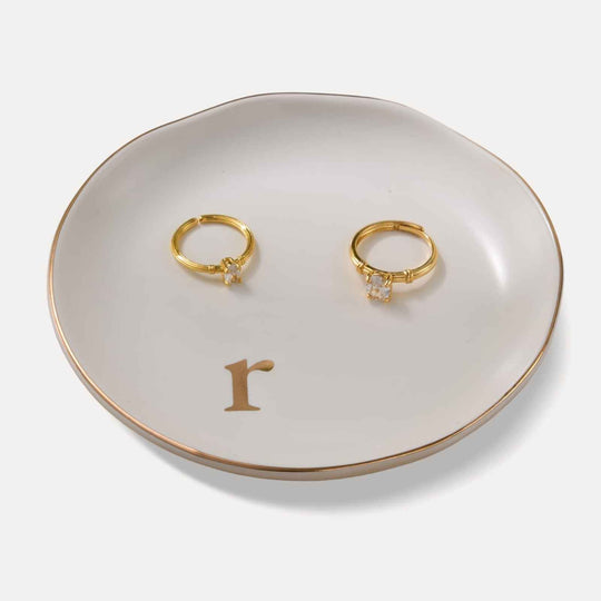 A Lolalet white ceramic jewelry dish featuring a gold 