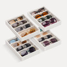 Lolalet 8-grid velvet sunglasses organizer tray displayed on a dresser, neatly holding various styles of men's and women's eyewear.