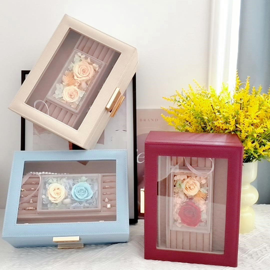 Elegant jewelry organizer box with a glass lid showcasing a single red preserved rose inside