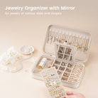 The Lolalet travel jewelry case filled with necklaces, rings, and bracelets to demonstrate its large storage capacity for travel.