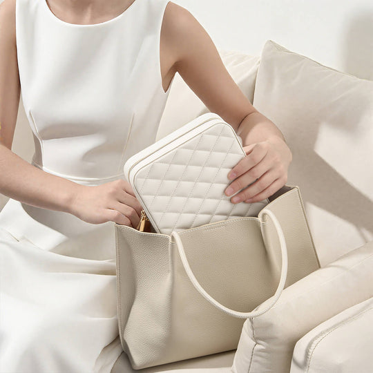 The small and portable white Lolalet travel jewelry case held in a woman's hand, perfect for packing in a suitcase or carry-on.