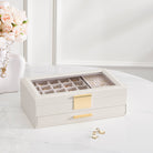 The sleek, white Lolalet 4-tier earring storage box, shown closed, highlighting its compact vertical design and glass display top.