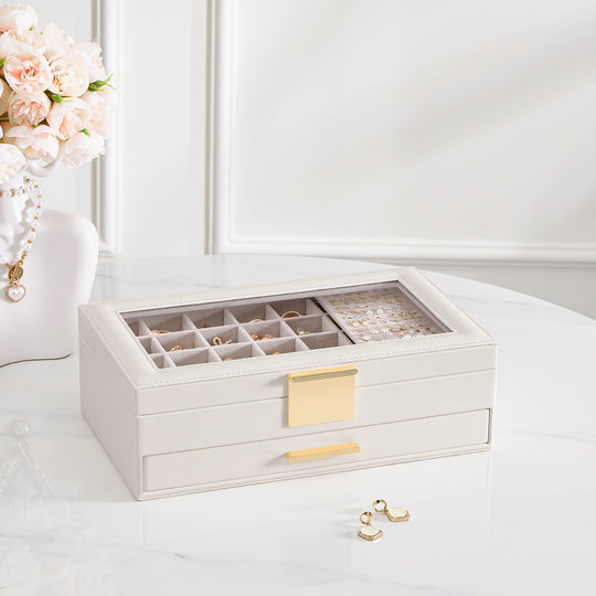The sleek, white Lolalet 4-tier earring storage box, shown closed, highlighting its compact vertical design and glass display top.