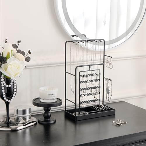 The elegant rotating jewelry tower sitting on a dresser, turning a jewelry collection into a functional piece of decor.