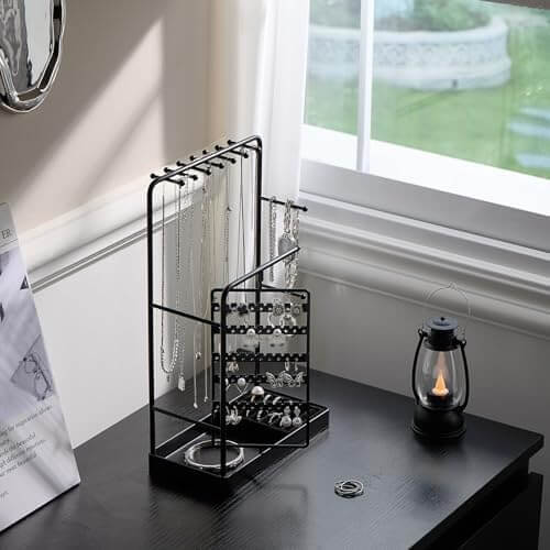 The elegant rotating jewelry tower sitting on a dresser, turning a jewelry collection into a functional piece of decor.
