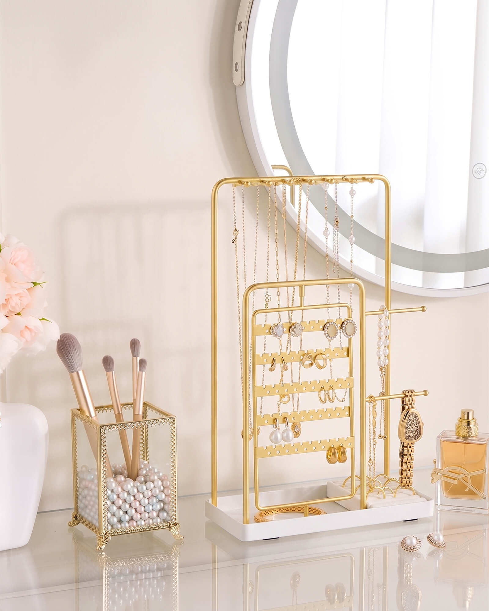 gold jewelry organizer stand showing rotating earring rack