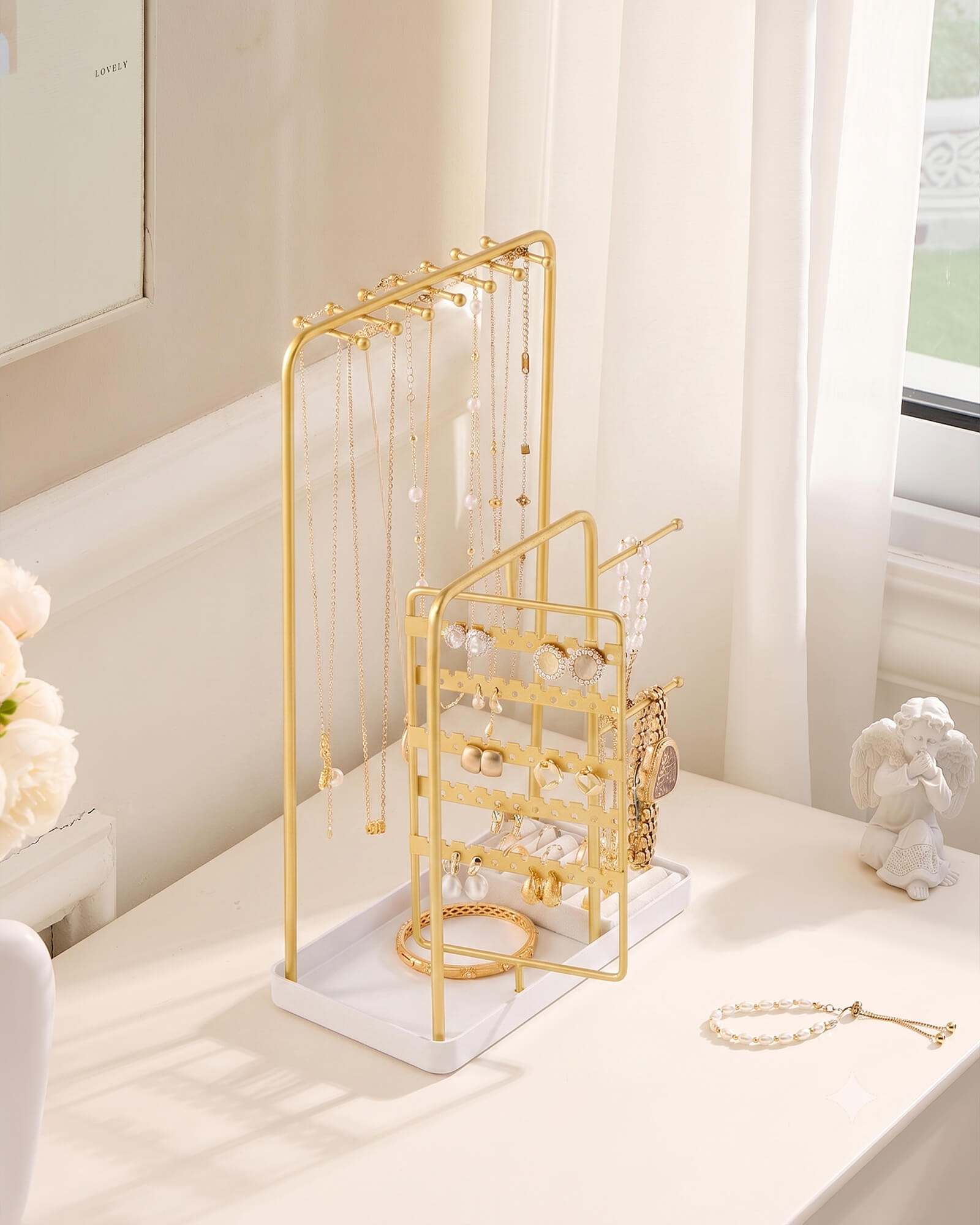 gold jewelry organizer stand showing velvet ring tray