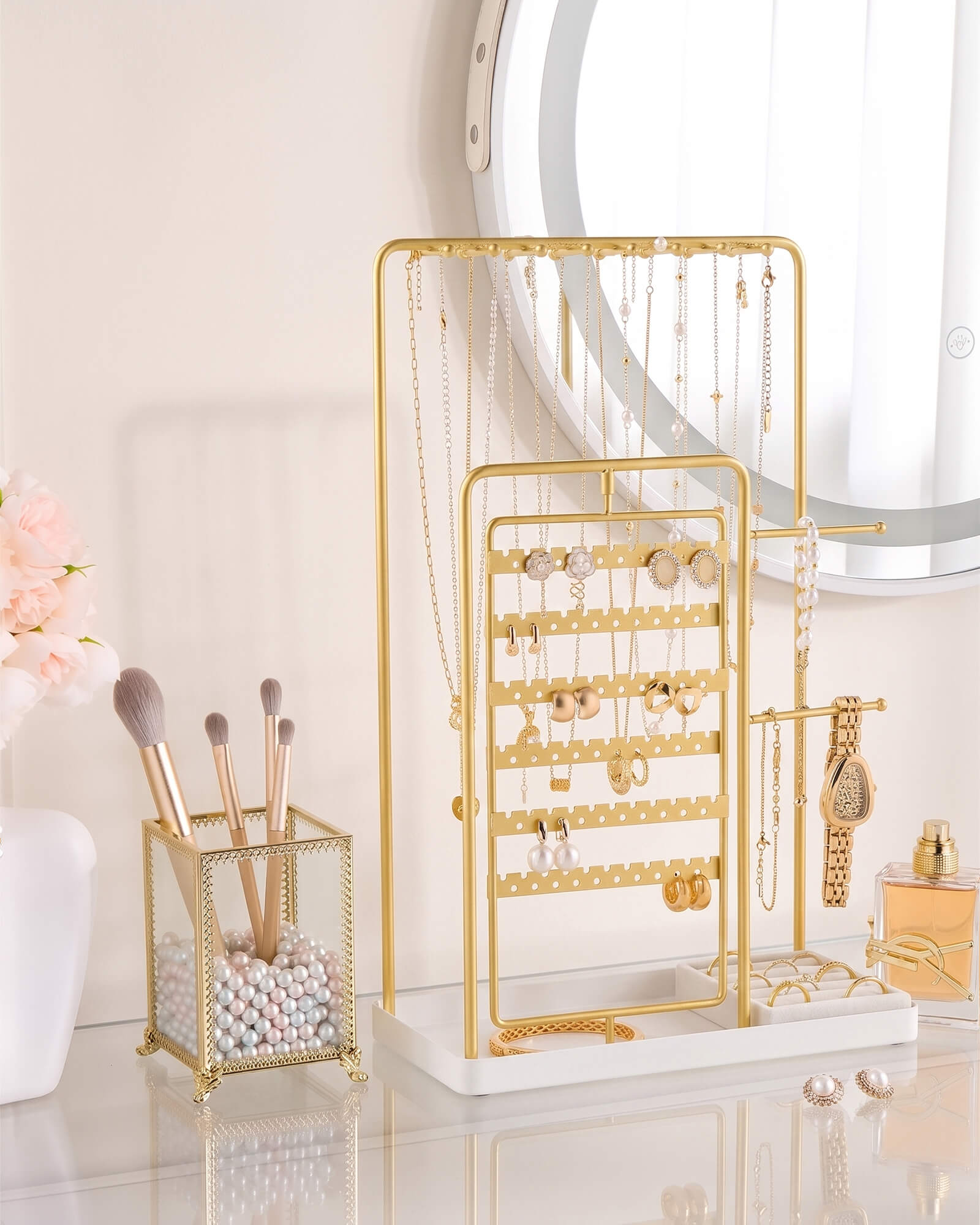 large gold jewelry organizer stand showing rotating earring rack