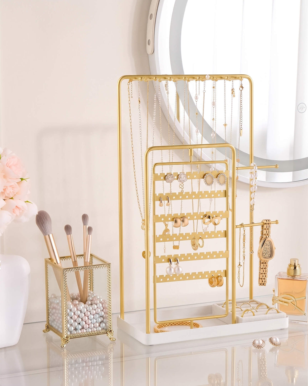 large gold jewelry organizer stand showing rotating earring rack
