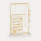 A Black rotating jewelry organizer tower displaying a full collection of earrings, necklaces, bracelets, and rings.